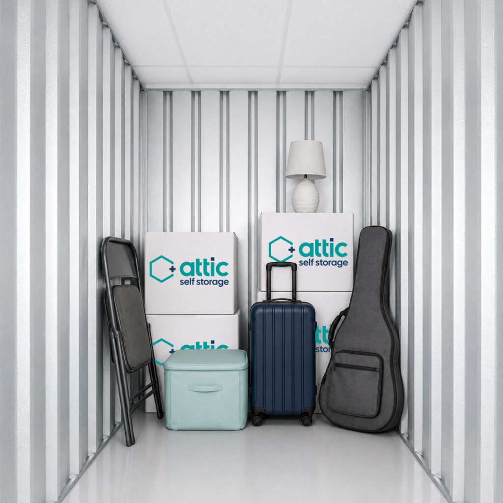 25 sq ft storage unit partially filled with moving boxes, suitcase and household items