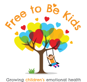 A child swings on a swing set under a tree with red heart shapes on its branches. Text above the image is "Free to Be Kids".